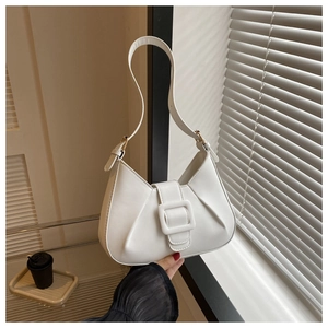 Detail of white pleated shoulder bag featuring a sleek square buckle and smooth PU leather