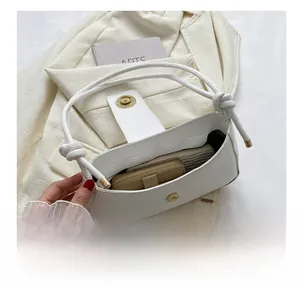 Internal view of the white minimalist handbag showing spacious capacity for essentials
