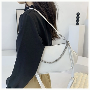 Minimalist white shoulder bag with silver chain detail and small round coin purse attachment