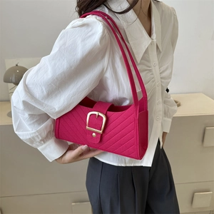 Rose red shoulder bag in textured quilted fabric with a large gold buckle detail