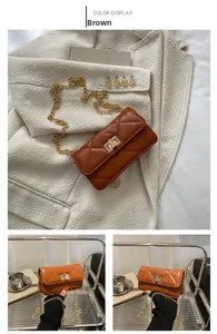 Detail view of brown quilted crossbody bag with gold metal chain and twist lock closure