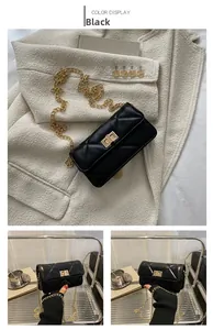 Detail of black quilted leather crossbody bag with gold chain strap and metal turn-lock