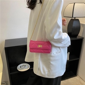 Pink quilted square chain bag with gold hardware worn as a crossbody shoulder bag