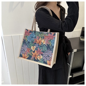 Detailed view of vintage floral jacquard pattern and texture on a beige tote bag