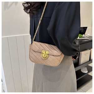 Detail of apricot quilted faux leather crossbody bag with golden Gancini style lock