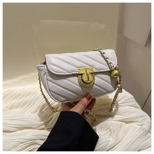 Detail of white quilted crossbody bag featuring gold chain strap and metal clasp