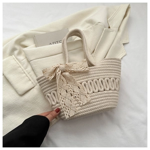 Close-up of beige woven tote bag with 3D wave texture and lace bow decorative detail