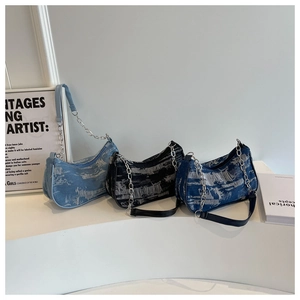 Three distressed denim underarm bags in light blue, black, and dark blue with chain straps