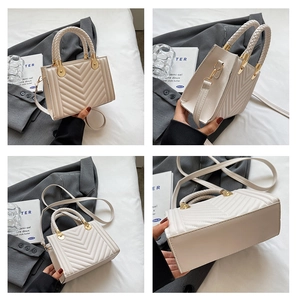 Detail view of cream quilted tote bag showing woven handles and elegant V-shape stitching