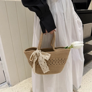 French vintage woven tote bag with white lace bow and tulip in a minimalist setting