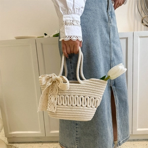 Chic beige woven tote bag with lace bow and hollow pattern for women fashion