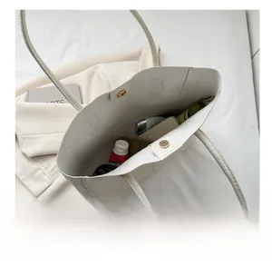 Top view of white crocodile pattern tote bag interior showing large capacity space