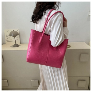 Crocodile pattern rose pink tote bag shown as lifestyle carry for daily commuting style