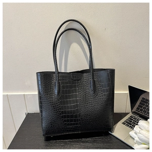 Close-up of elegant black crocodile texture and premium material on large tote bag