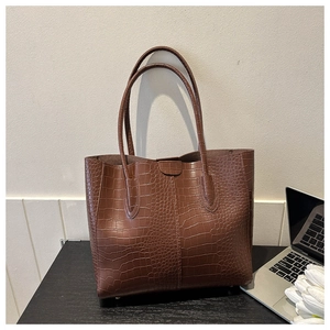 Deep brown tote bag with crocodile embossing and long dual handles for commuting