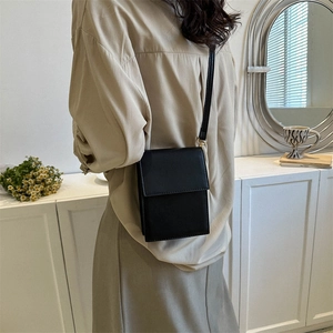 Minimalist black PU leather crossbody bag with flap and gold hardware for daily commute