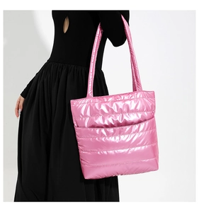 Close-up of pink metallic quilted tote bag with horizontal stitching and front pocket