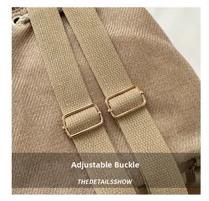 Detailed macro view of khaki canvas straps with adjustable rose gold metal buckles