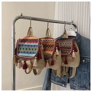 Bohemian style backpacks featuring colorful geometric wave patterns and fringe tassels