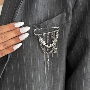 Silver fringe safety pin brooch with heart pendants on grey striped suit jacket