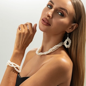 Elegant multi-layer white pearl jewelry set with necklace bracelet and earrings on model
