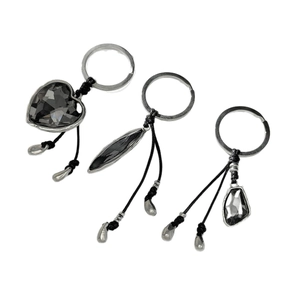 Three grey crystal heart and geometric charms with silver frames on black cords