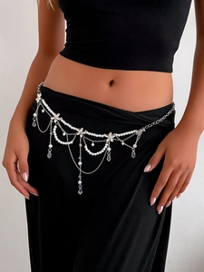 Detail of layered pearl tassel waist chain with silver charms and crystal droplets