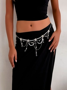 Detail of multilayer silver belly chain with white pearls and crystal water drop pendants
