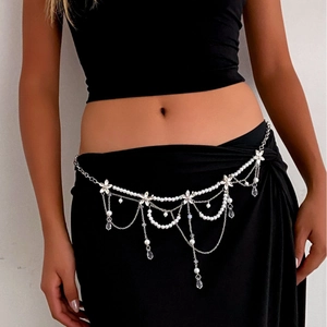 Elegant multi-layer waist chain with crystals and pearls on a black dress backdrop