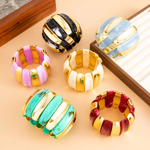 Detail of wide stretch bracelets in six colors showing acrylic and metal splice texture
