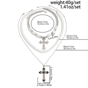 Detailed view of triple-layered necklace with pearl beads and cross pendants
