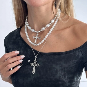 Detail of layered gothic necklace with baroque pearls, silver chains and crystal crosses
