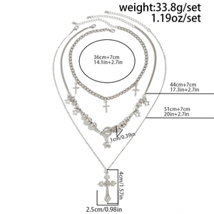 Detailed view of layered silver necklace featuring cross pendants and star charms with sizes