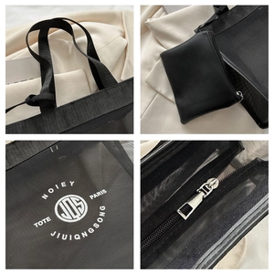 Detail view of black mesh tote bag with inner leather pouch and logo print details