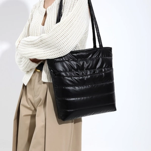 Minimalist black quilted down tote bag for women showing large capacity and shiny texture
