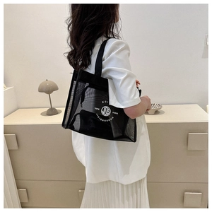 Detailed side view of a black mesh tote bag featuring a white circular graphic logo