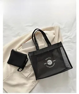 Detail of black mesh tote bag set with matching zippered pouch on neutral background