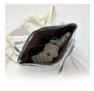 Top view of silver tote bag interior showing large capacity for phone and essentials