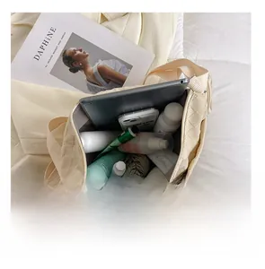 Detailed internal view of beige checkerboard canvas tote showing large storage capacity