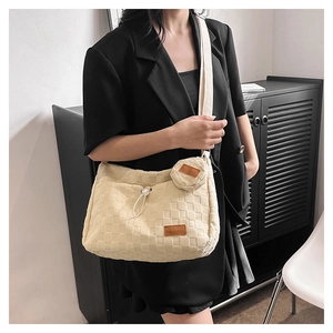 Detail of beige checkerboard canvas bag with mini round coin purse and drawstring closure