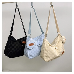 Detail of checkered canvas tote bag with matching round coin purse and zipper closure