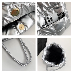 Detail of silver quilted puffer bag showing magnetic clasp closure and interior storage