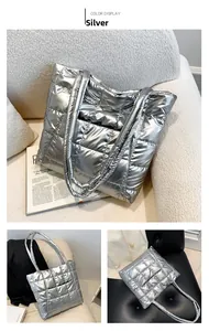 Close-up of quilted silver tote bag with metallic finish and padded down jacket texture