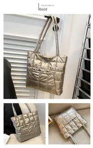 Detail of golden quilted tote bag with metallic finish and long double shoulder straps