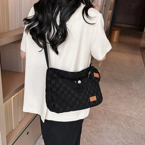 Minimalist black checkered crossbody bag with detachable round coin purse on strap