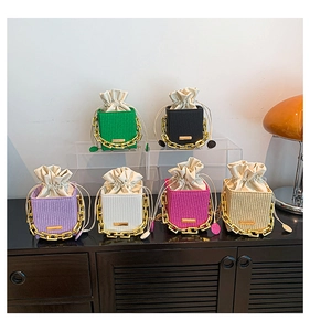 Detail of mini woven bucket bags with chunky gold chain straps in six vibrant colors