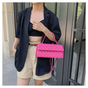 Street style view of a rose pink quilted flap bag worn as a chic crossbody handbag