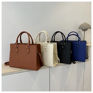 Chic commuter tote bags in brown beige black and blue with gold hardware details
