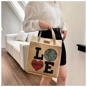 Detail of canvas tote bag with LOVE print and earth heart design on brown jute fabric