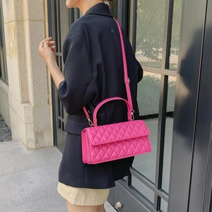 Fashionable rose pink quilted crossbody bag with gold hardware and top handle strap
